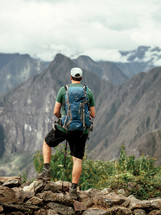 A hiker looks at a mountain view.