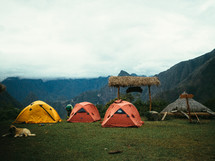 Tents pitched on a mountaintop.