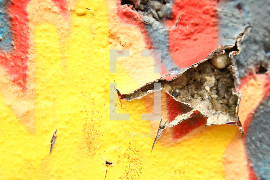 peeling paint of a wall covered in graffiti 