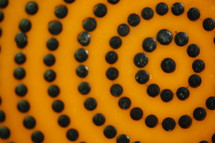 radiating black beads on orange 