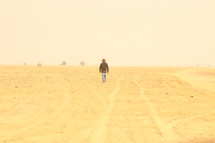man walking through the desert 