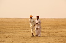 men walking in a desert 