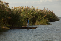 A man fishing in a river in Malawi, Africa