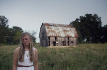 woman and an abandoned barn 