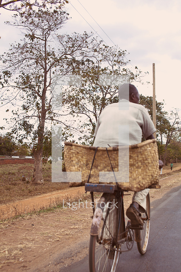 A man riding a bicycle in Malawi Africa. 