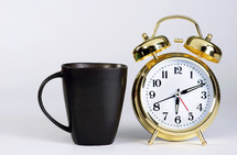 coffee mug and alarm clock 