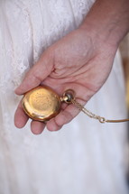 bride holding a pocket watch 