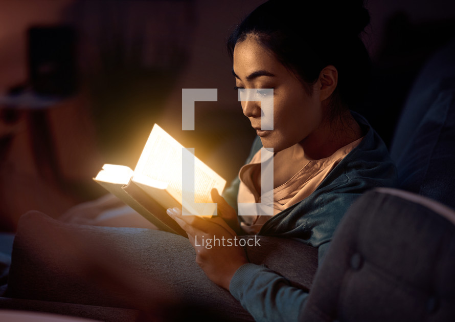 Woman reading illuminated Bible