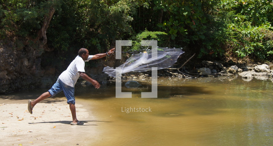 Fisherman tossing a throw net to catch fish