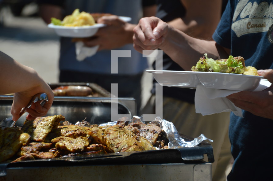 Getting steaks and salad at a church cookout — Photo — Lightstock