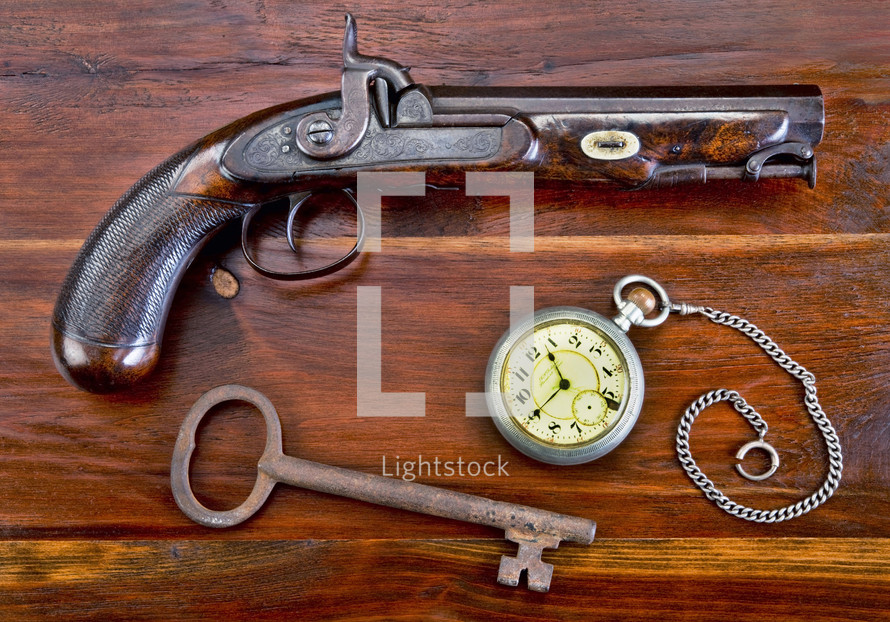 vintage gun, pocket watch, and skeleton key 
