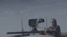a man with a video camera mounted to the roof of his car 