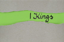 Title 1 Kings - torn open kraft paper over green paper with the name of the book 1 Kings