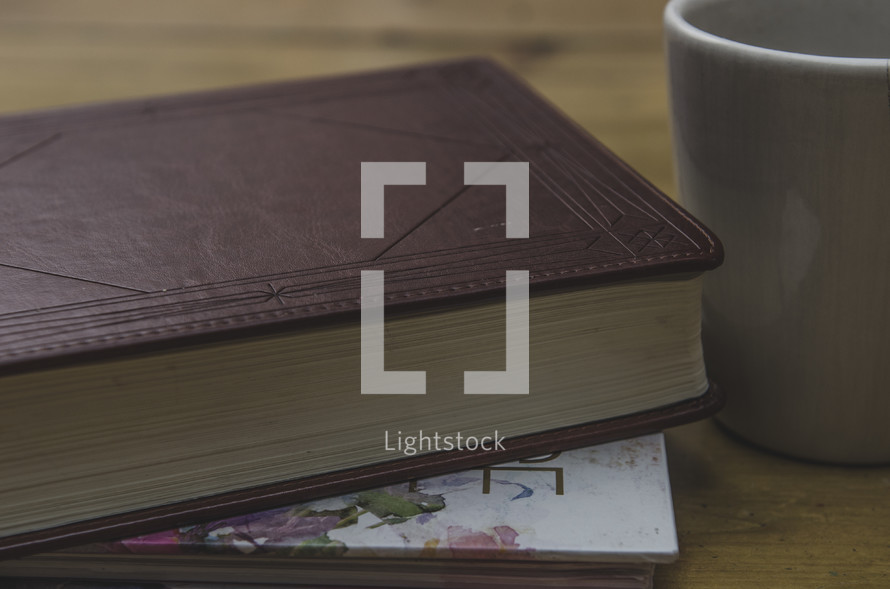 Bible, journal, and coffee mug on a table 