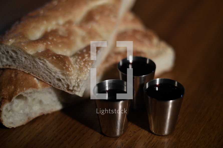 The Lord's Supper with pieces of bread and three goblets of wine 