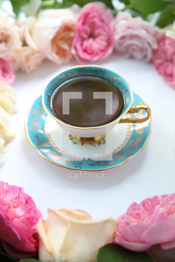 circle of flowers around a tea cup 