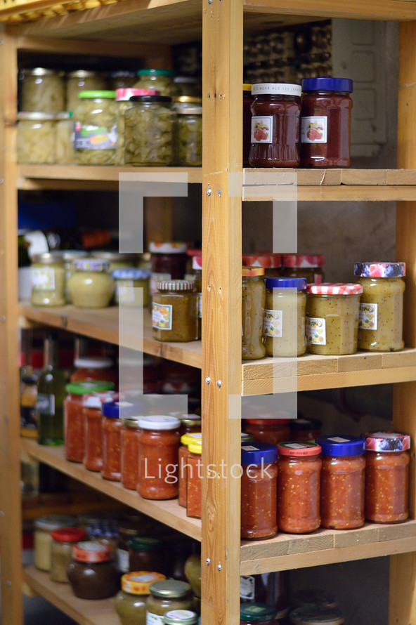 jars of preserved food on a pantry shelf 