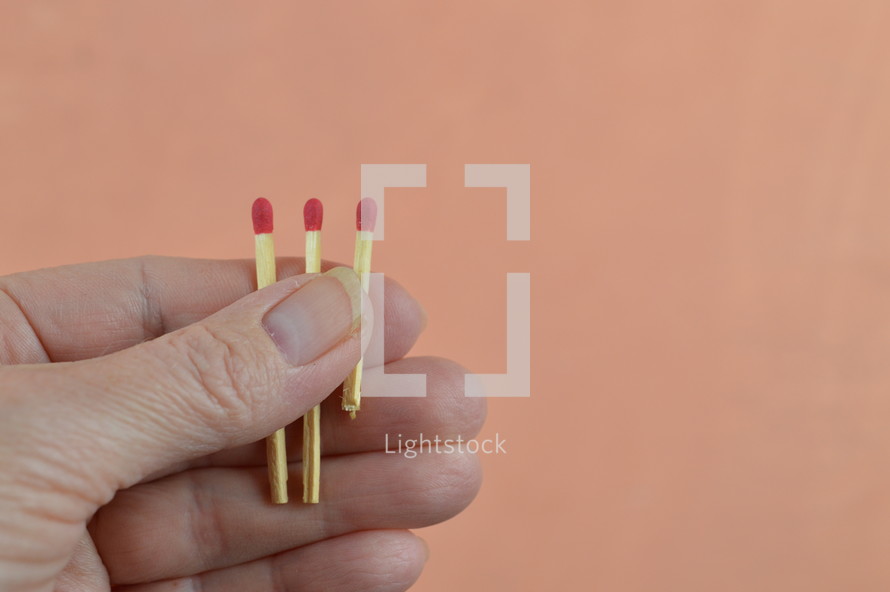 a person holding matches in their hand 