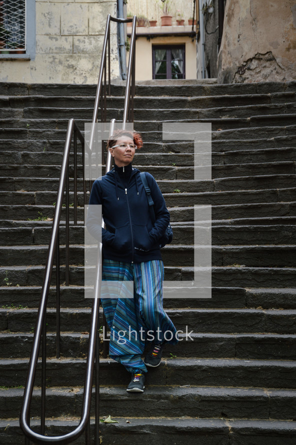 a woman walking down steps 
