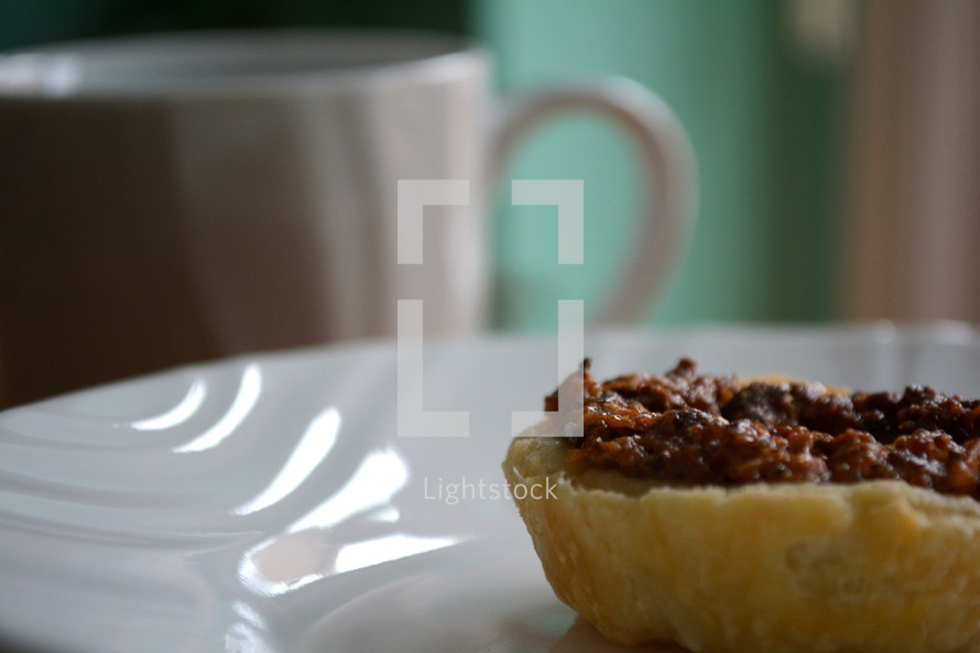 pastry on a plate and mug 
