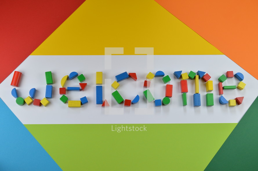 welcome - word welcome of colorful toy wooden blocks on colorful background