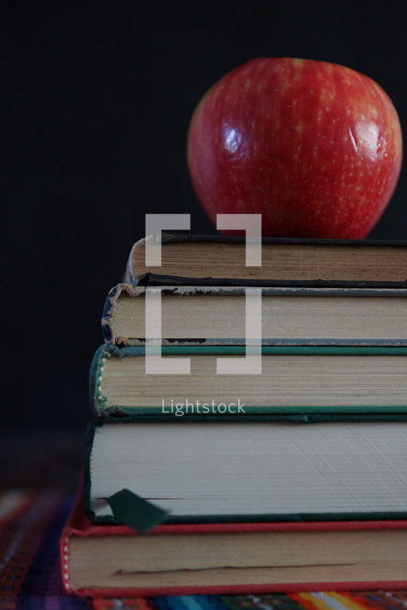 apple on a stack of book 