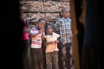 innocent children leaning against a wall in Africa 