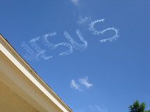 The name above all names - The name of Jesus is written in the sky by a small crop duster airplane on a clear sunny day. The Lord is always there if we just bother to look up and see His presence. 
