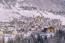 Snowy stone buildings in the mountain village 