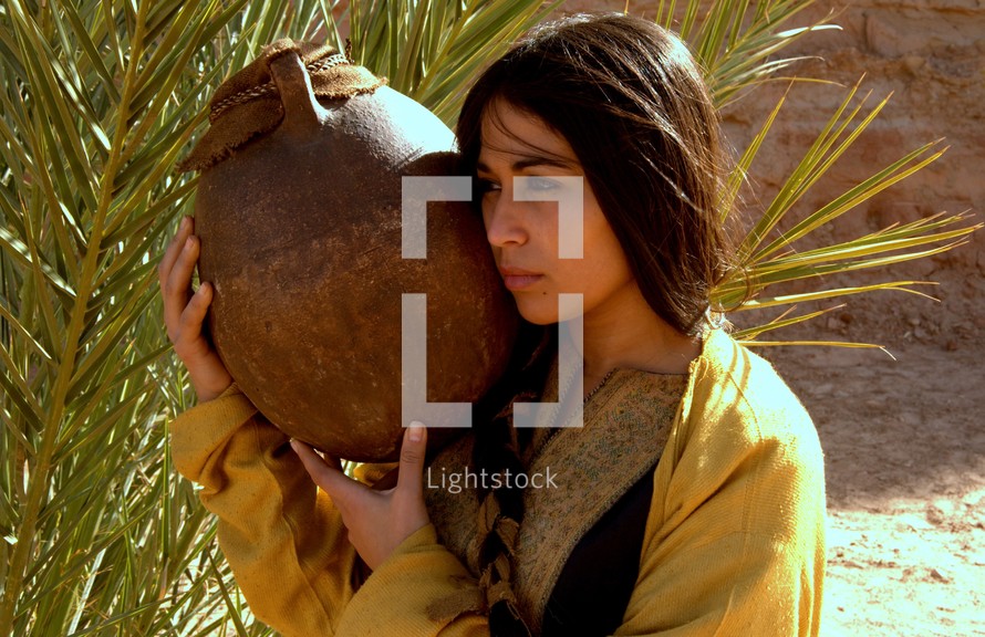 woman in biblical times carrying clay pot 