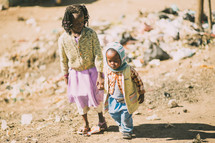 children walking holding hands 