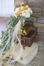 bridal bouquet on luggage 