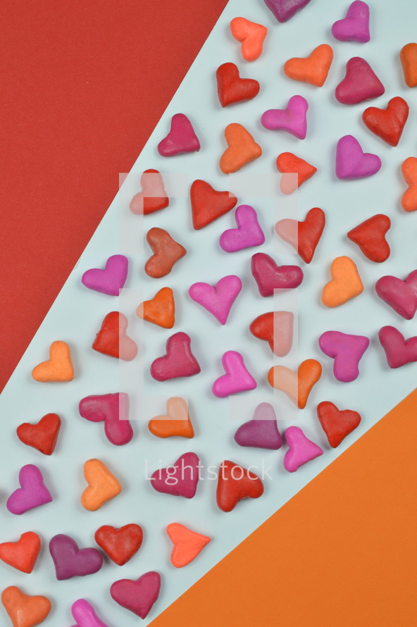 colorful heart shapes on red, yellow, and white background 