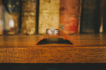 rings laying on book spine  - table 