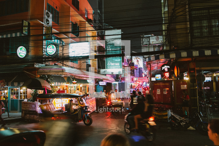 Busy city street in Thailand at night. 