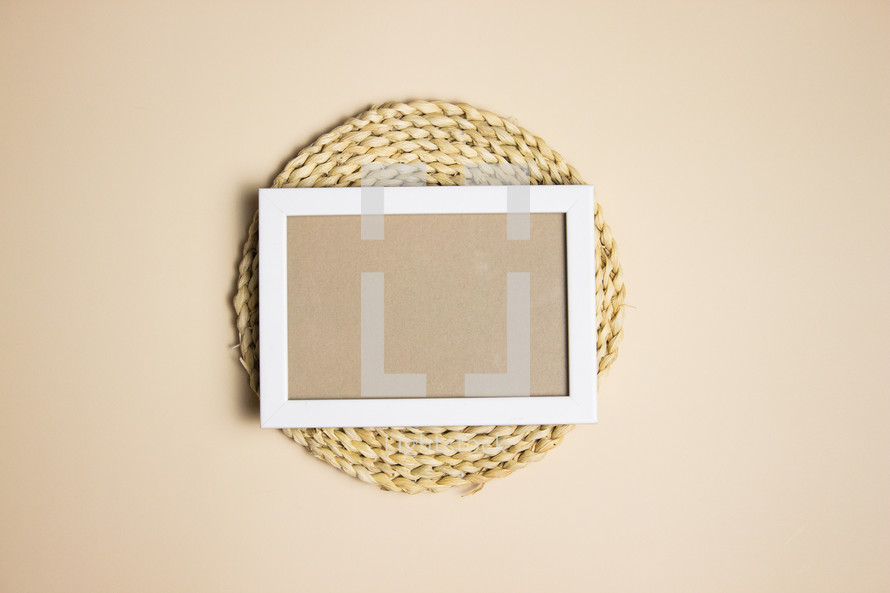White frame with blank tan note on braided circl