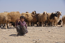 Shepherd boy in a sandy desert