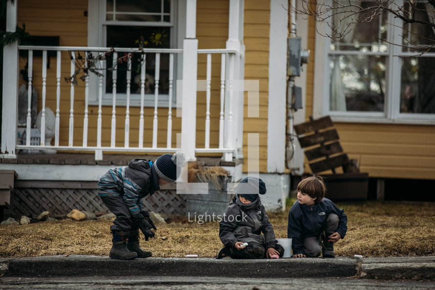 boys playing in a front yard 