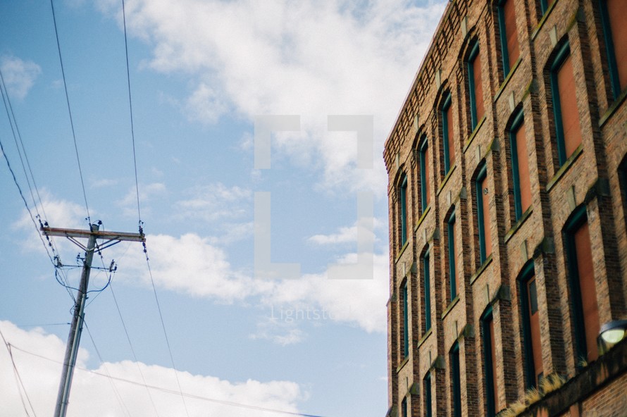 power lines and an old brick warehouse building 