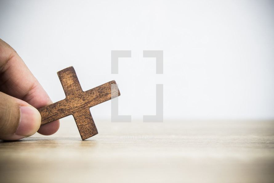 hand holding a cross 