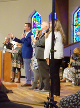 choir singing on stage during a worship service 
