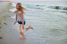 girl child running on the beach 