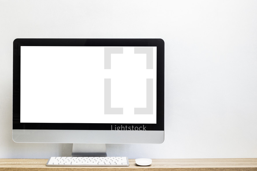 blank computer screen on a desk 