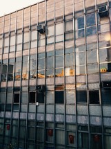 air conditioner units in windows of a commercial building 