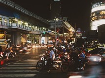 motorcycles on a busy city street at night