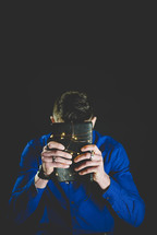 man holding a Bible wrapped in fairy lights 