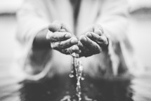 water in cupped hands of Christ 