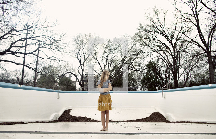 woman standing in an empty pool