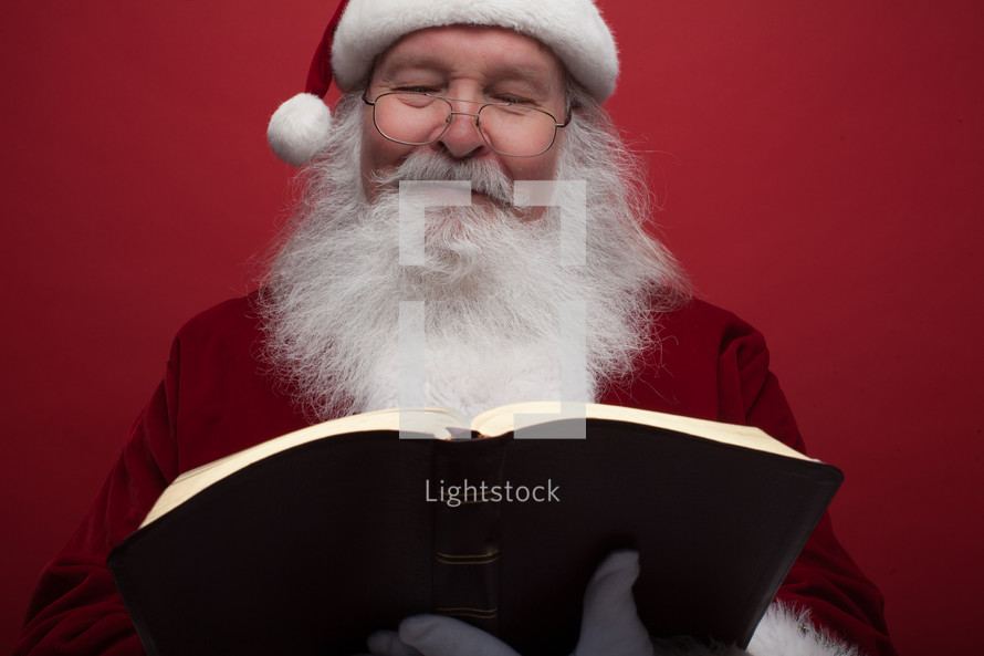 Santa Claus reading a Bible 