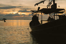 A fishing boat on the water at dusk. 